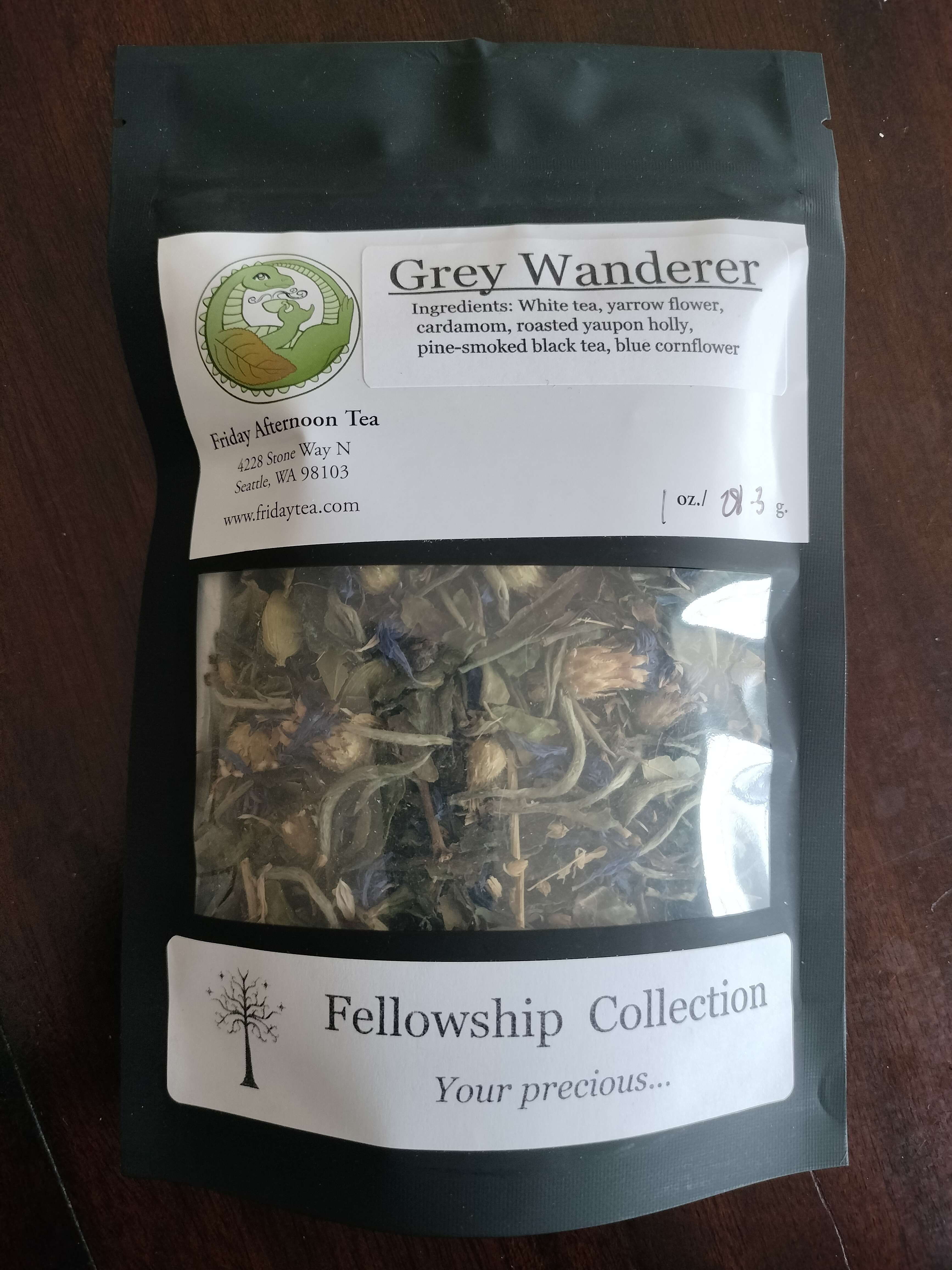 The tea blend Grey Wanderer from Friday Afternoon Tea. Ingredients are White tea, yarrow flower, cardamom, roasted yaupon holly, pine-smoked black tea, and blue cornflower.